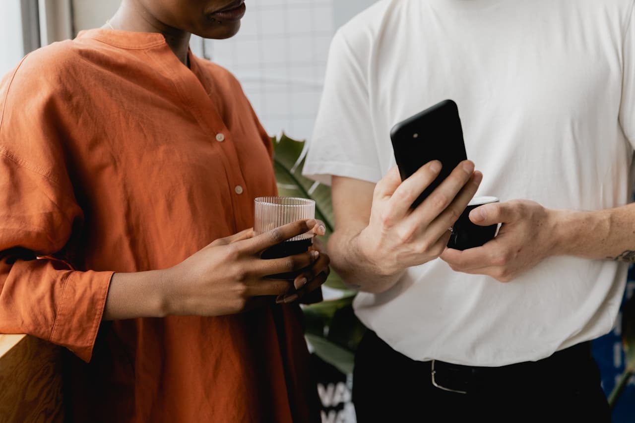 Man showing a woman a post on his phone